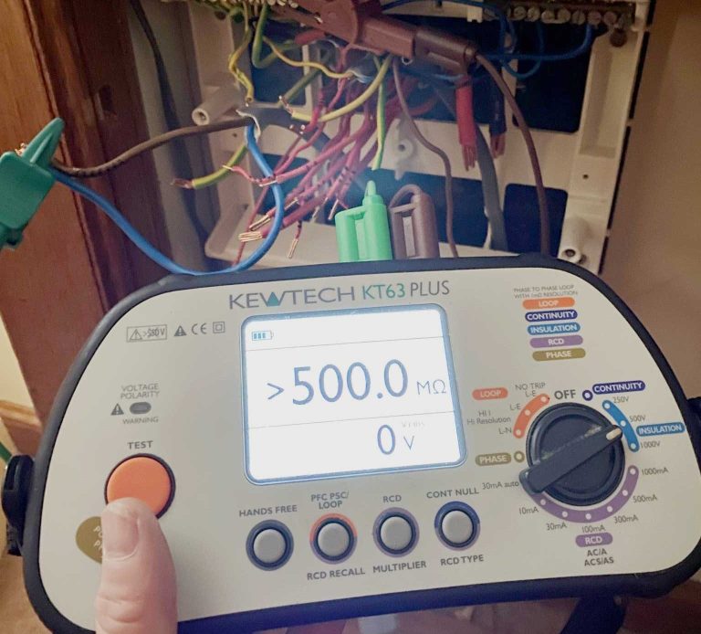Electrical testing equipment (KT63PLUS multifunction tester) being used by the KF Watson team to check wiring installation