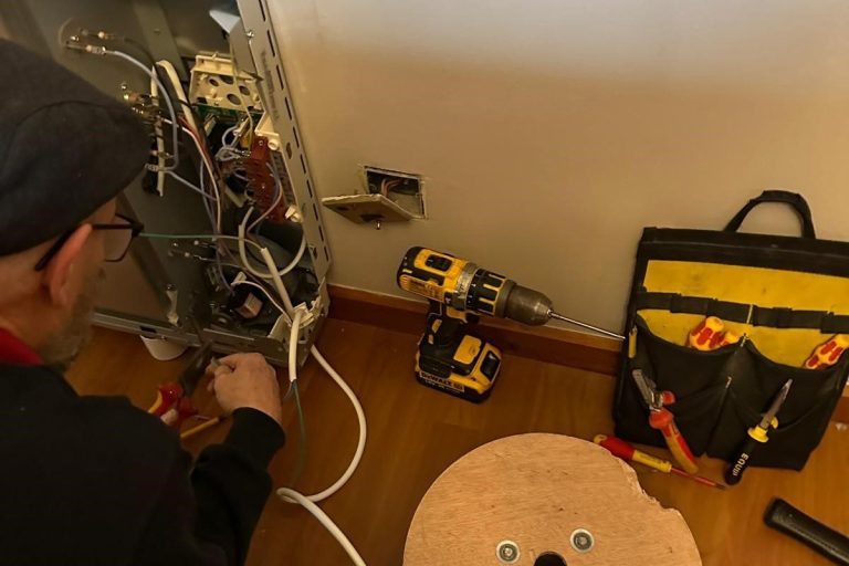 KF Watson engineer working on a Dimplex electric wall mounted heater / radiator
