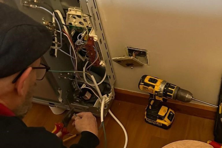 KF Watson engineer working on a Dimplex electric wall mounted heater / radiator